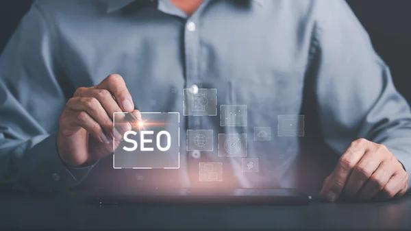 Marketer holding pen pointing to SEO icon, optimization analysis tools, search engine rankings, social media sites based on results analysis data,Ranking the best sites for search,online marketing