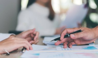 Business people read business statistics chart reports, to analyze and improve corporate strategy, manage financial and marketing documents, update annual budget accounts, company growth data.	