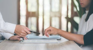 broker sends pens and papers for the client to sign for deal,business document management and agreements business contract signing Approval of contract or warranty documents,investment loan approval