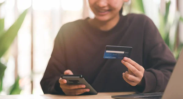 Consumers hold credit cards ,Shopping concept, online web shopping and home delivery service, connects merchants and customers worldwide, online payment, consumer society, cashless society