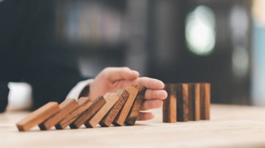 protection and risk management, Financial risk management ,Business Investment Feasibility Assessment, protection of business interests, Human hands blocking wooden sticks