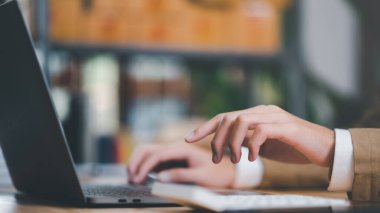 accountant calculating figures in company financial online documents with a calculator,analysis of company financial data,Planning to assess and review budgets,concept of finance and investment