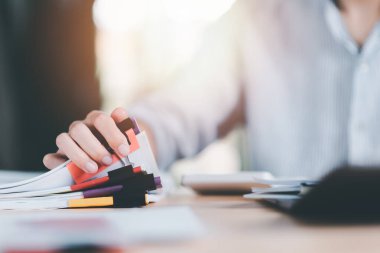 business accounting documents,auditor,management and auditing of office documents,Reports for Tax Time Analysis,office worker working with documents at home office desk,work at home