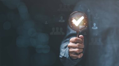 concept of business development with personnel ,Choosing a professional leader ,recruitment ,HRM or Human Resource Management ,corporate executive holding a magnifying glass and a check mark icon ,