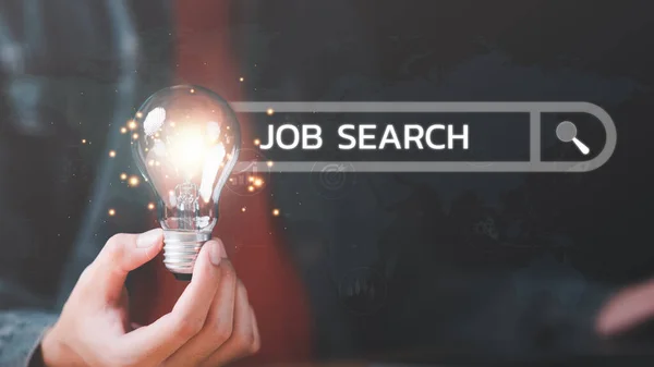 Man holding light bulb showing online job search concept ,career search ideas, recruitment, unemployed person ,new graduates ,job shortage ,economic downturn ,unemployment ,dismissal