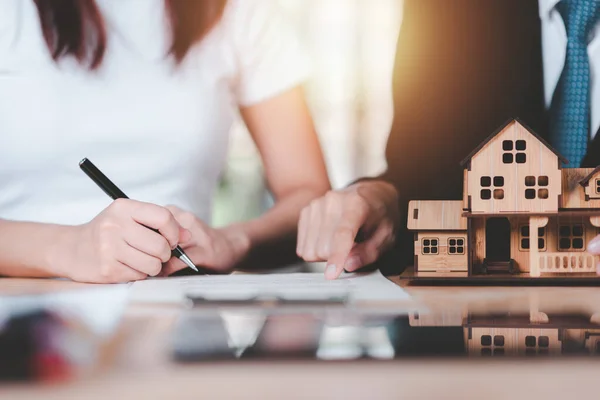 customer checking loan agreement with real estate agent ,Investment loan approval concepts to build residential homes, real estate business ,appraisal of property value ,Signing to approve contract