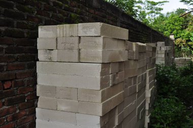 brick wall with a large stone