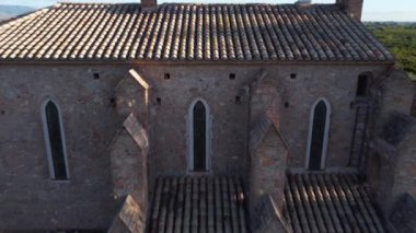 4K drone footage of a flight over Santa Barbara ancient church among orange trees in Spain. High-quality 4k footage
