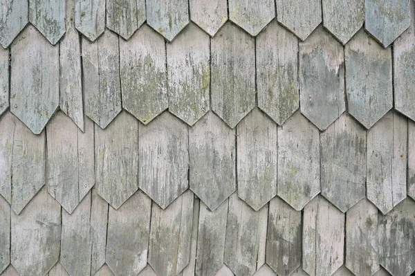 Vertical color close-up image of old wooden tile pattern facade. High-quality photo