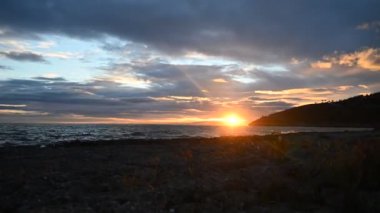 Time-lapse shot of colorful clouds passing over Torre de la Cords in Oropesa, Spain. High-quality 4k footage