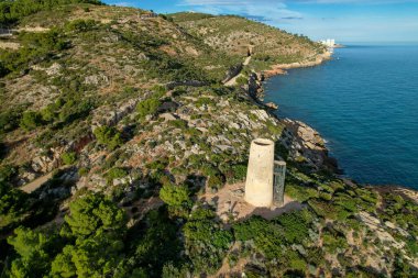 Drone top view of Torre de la Corda medieval defensive tower on a hill next to the Mediterranean seashore in Oropesa, Spain