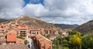 Colorful panoramic view of the medieval small village of Albarracin and its defensive wall in Autumn. High-quality photo