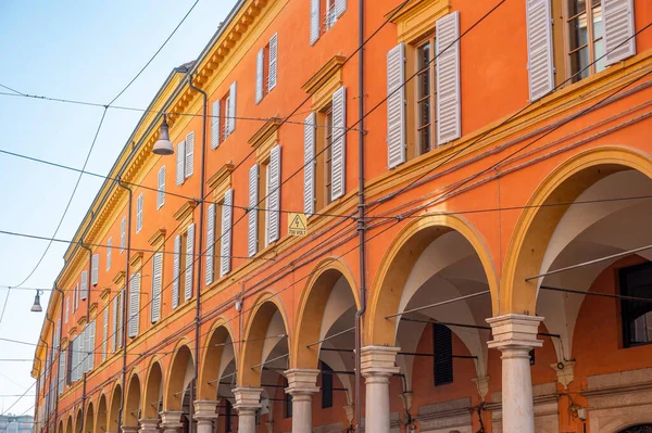 Low Angle wide View Of orange Historical Building in Modena with arcs, Emilia Romagna, Italy. High-quality photo
