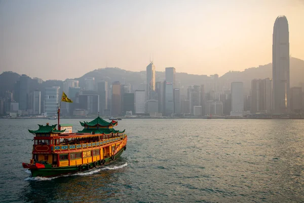 Junk Boat in Hong Kong Victoria Harbour at sunset - stock photo. High quality photo