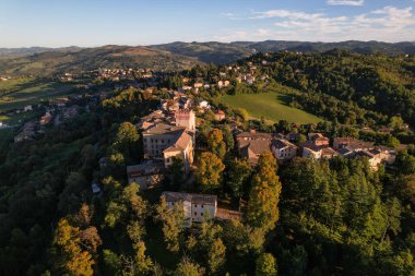 4k drone flight over the Castle of Guiglia and its forest at golden hour in Italy. High-quality photo