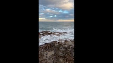 Vertical 4k lateral movement sunset footage of the Mediterranean coastline in Oropesa del Mar, Spain. High-quality 4k footage