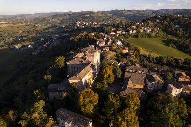 4k drone flight over the Castle of Guiglia and its forest at golden hour in Italy. High-quality photo