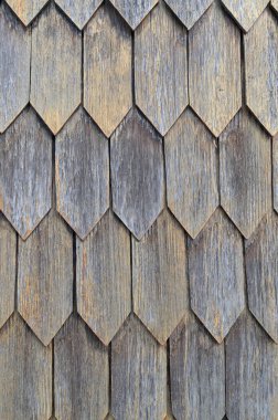 Vertical color close-up image of old wooden tile pattern facade. High-quality photo