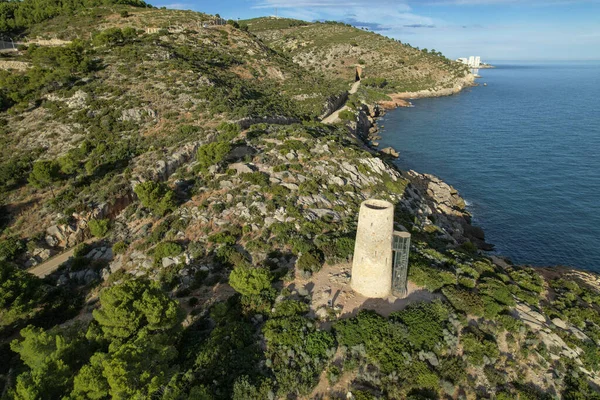 Drone top view of Torre de la Corda medieval defensive tower on a hill next to the Mediterranean seashore in Oropesa, Spain