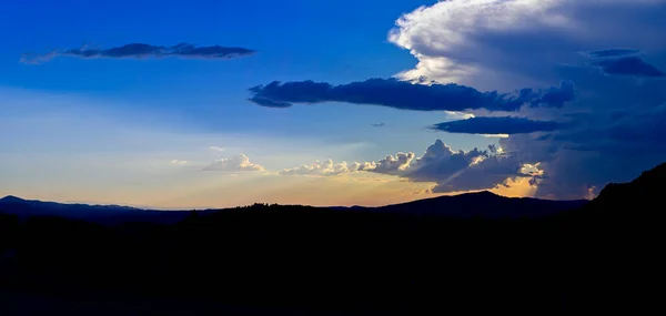 Dramatik panoramik süper hücreli yaz fırtınası günbatımında turuncu güneş ışınlarıyla birlikte. Yüksek kaliteli fotoğraf.