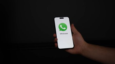 hand holding smartphone with app on screen