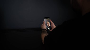 woman using smart watch on black background