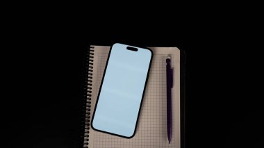 black smartphone and pen on a dark background