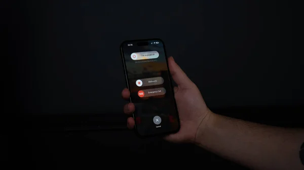Siyah arkaplanı olan akıllı bir telefonu tutan