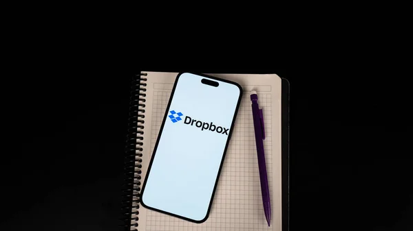 notepad with a pen on a black background