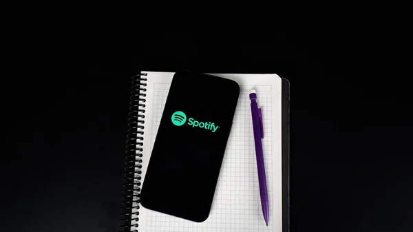 notepad with a pen and a notebook on a black background