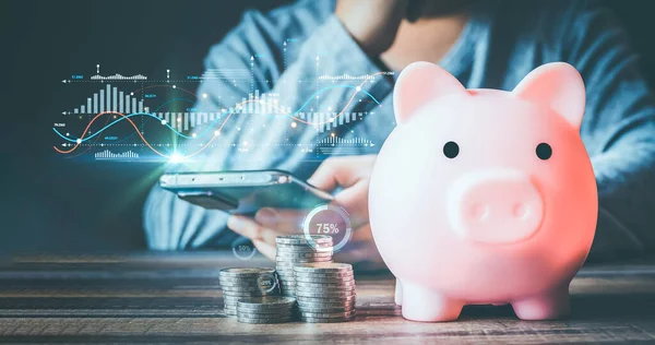 Businessmen use internet technology to analyze data graphs for financial planning. The goal is to invest wisely and save money for future expenses. piggy bank saving concept for financial stability.