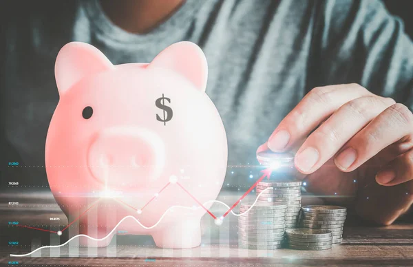 Businessmen use internet technology to analyze data graphs for financial planning. The goal is to invest wisely and save money for future expenses. piggy bank saving concept for financial stability.