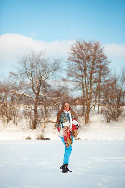 Winter trip to the lake. A white scarf, warm pants and a sincere smile. The joy of life. Europe in winter