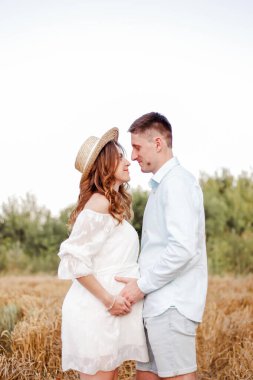 A couple in love look into each other's eyes and await the arrival of their little son. Love conquers the world. Smiles on the face