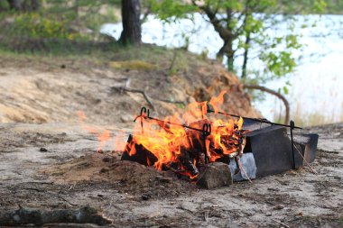 A fire is burning on the edge of the quarry. The power and beauty of nature