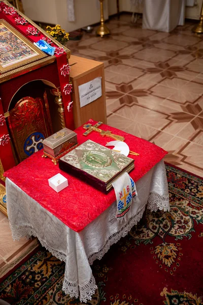 Vinnytsia, Ukraine. November 20, 2022: Bible in the Orthodox church. The sacrament of baptism and all the details. Icons on the table on the walls inside