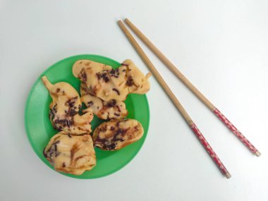 Yarı pişmiş Endonezya mini krepi (tutam kek veya kue cubit) üzerine çikolata serpiştirilmiş