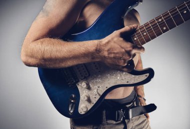 Guitar player holding guitar in hand clipart