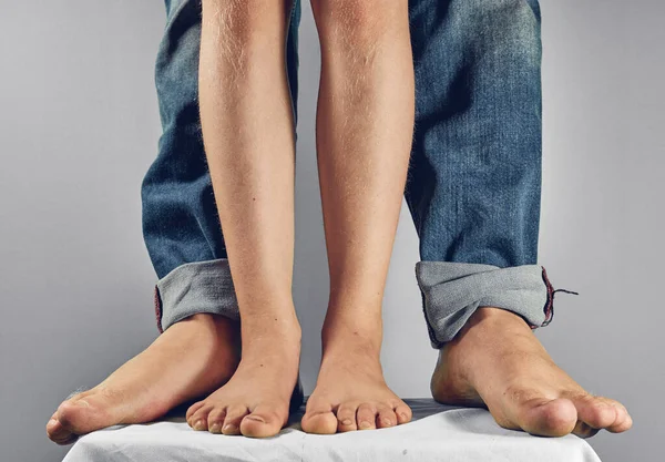 Daughter and fathers feet beside barefoot