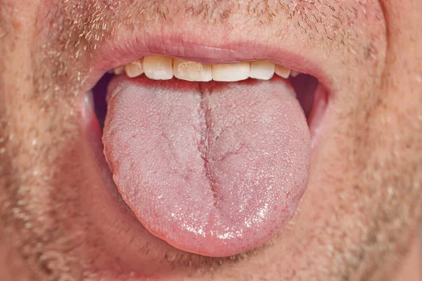 Closeup of male tounge with light beard