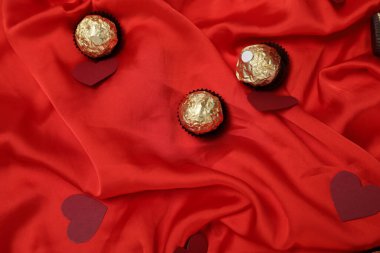 Valentine's Day background with red hearts, red roses wine bottle on red, white and black background. Valentine's Day, 14 February.