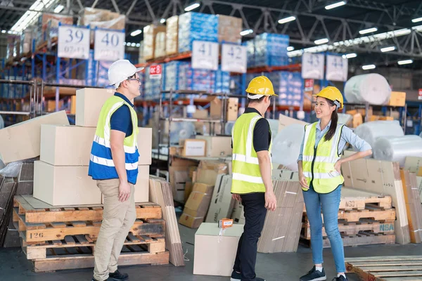 Staff in large storage warehouse together cheerful after work completed hand touching congrats