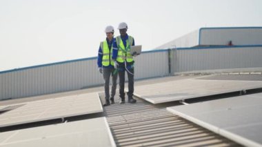 Güneş panelleri kurulum süreci, çatıdaki mühendisler mesaiden sonra mola veriyorlar 