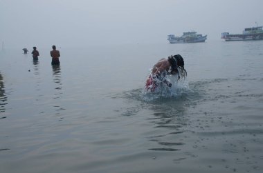 Pilgrims are taking bath in the auspices of Makar Sankranti at Ganga Sagar, West Bengal.