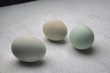 Salted duck eggs on a white table.