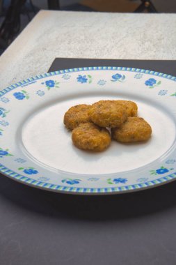Indonesian food called perkedel, on a classic white plate.