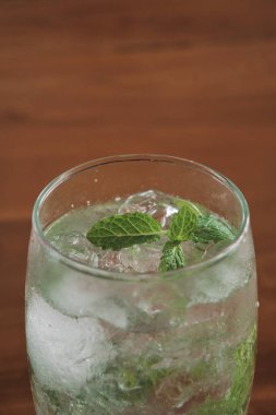 mojito drink on wooden table. natural light.