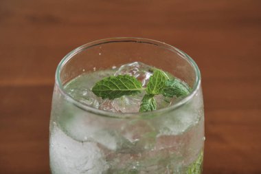 mojito drink on wooden table. natural light.