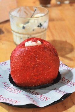 red velvet bomboloni cake on a wooden table. natural light.