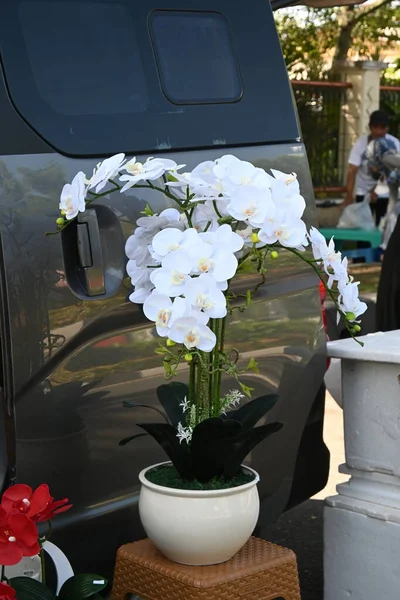 vases and fake flowers for sale at car free day events.